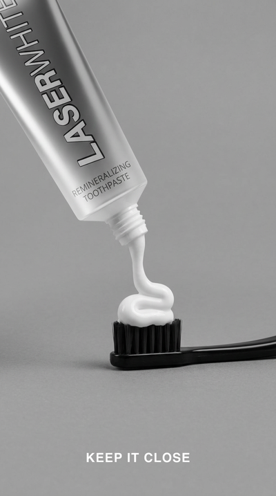 White nHA toothpaste on a black toothbrush