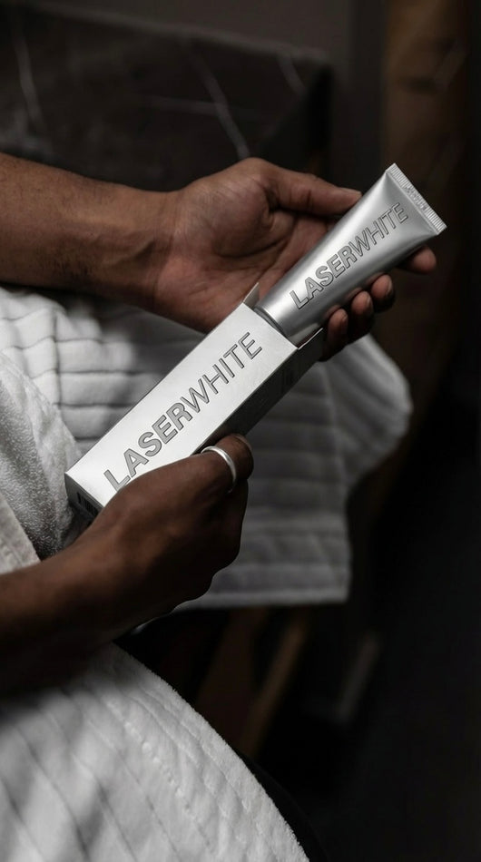 Man holding a LaserWhite toothpaste tube